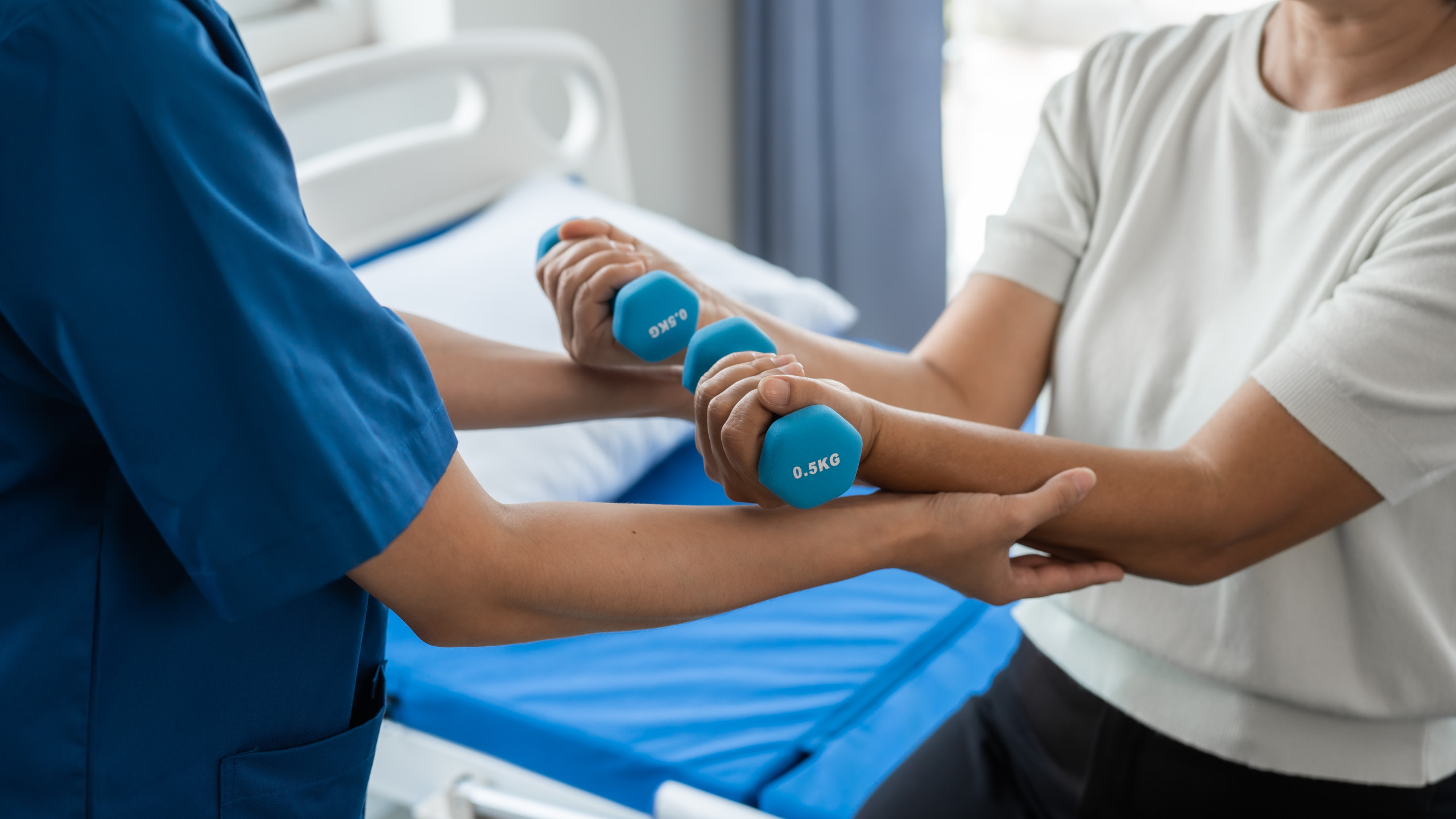 Young,Physiotherapist,Helping,Senior,Mature,Asian,Woman,Grey,Hair,Work