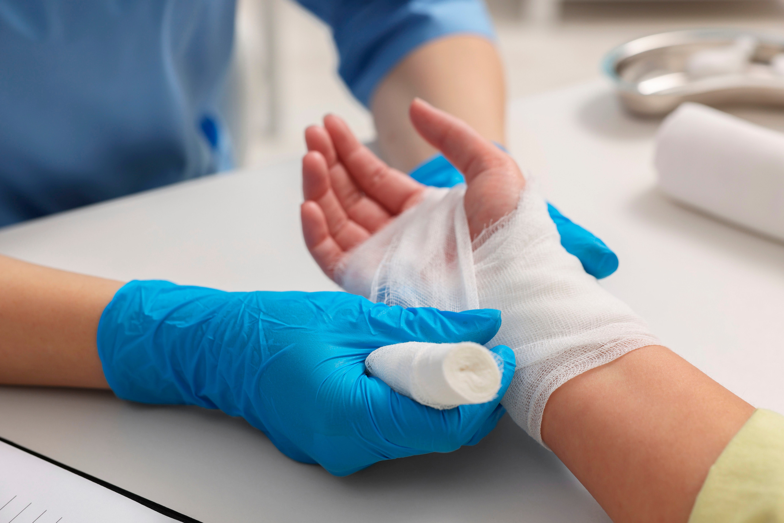 Doctor,Bandaging,Patient’s,Burned,Hand,Indoors,,Closeup Doctors in the Stroke Lab.