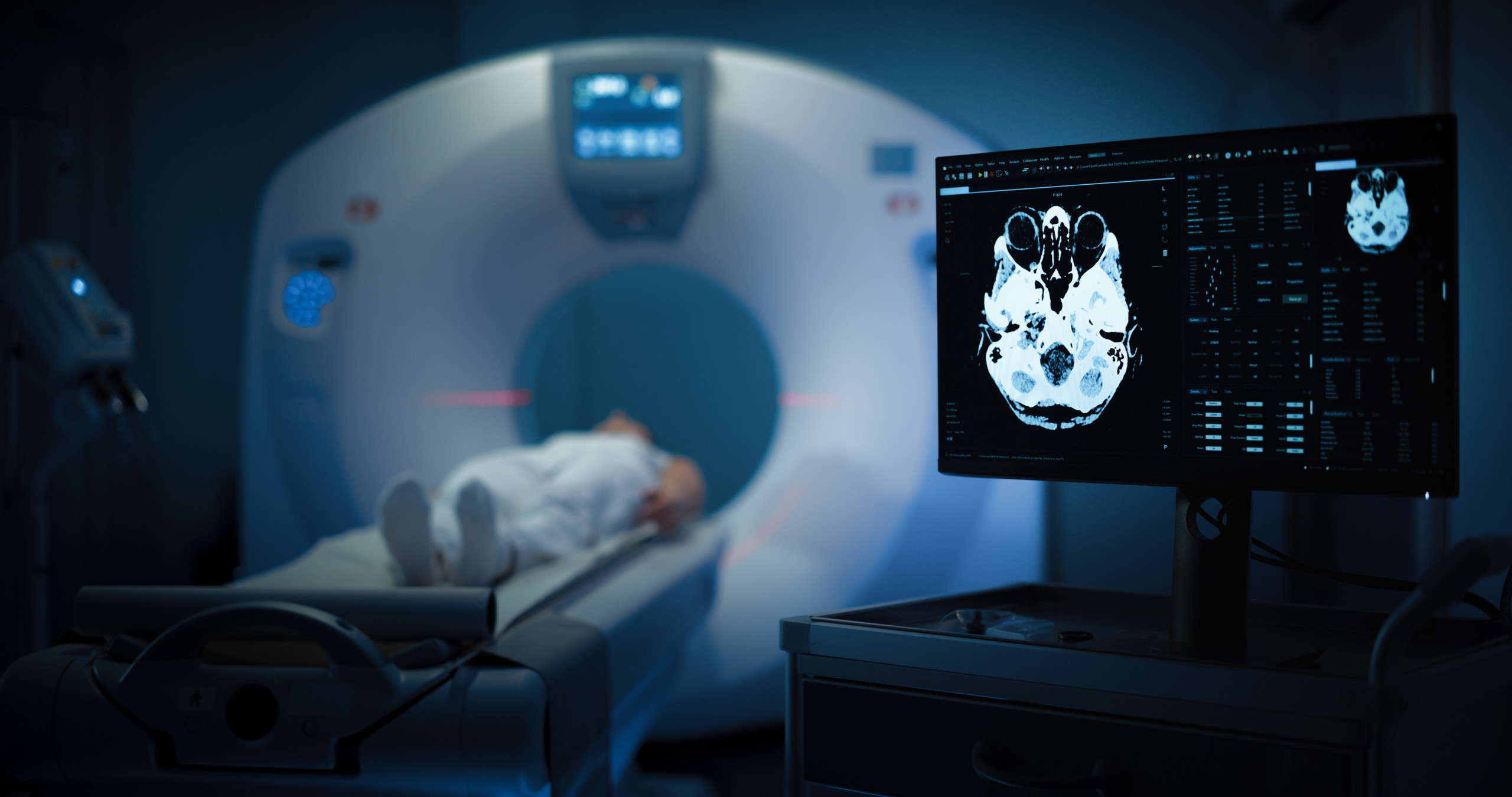 Medium,Shot,Of,A,Female,Patient,Lying,On,A,Ct Male nurse with male patient in hospital gown.