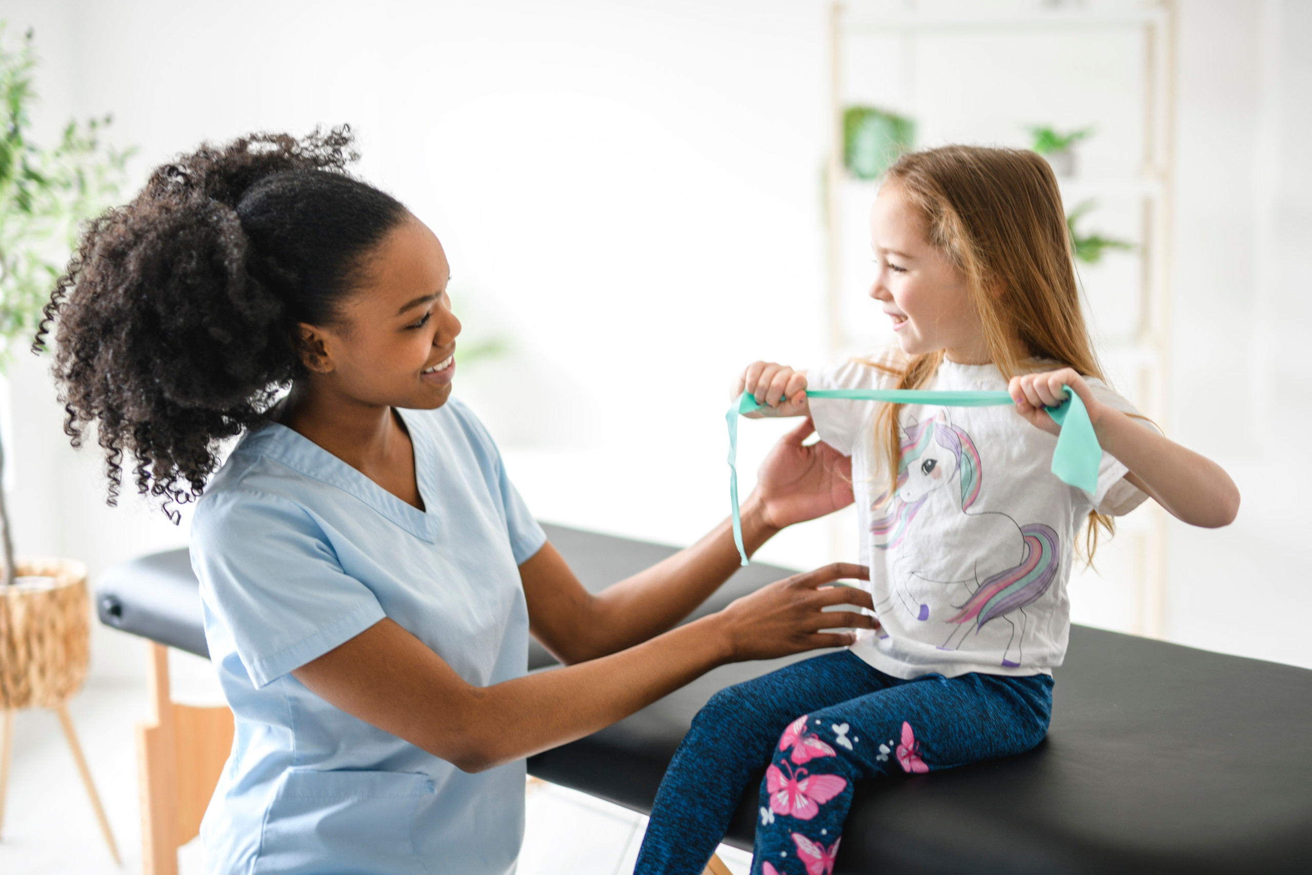 A,Physiotherapist,Working,With,Child,Girl,Patient,In,A,Rehab